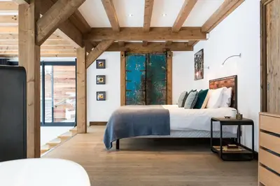 a bedroom with a bed in a room with wooden ceilings at Chalet Belachat in Chamonix-Mont-Blanc