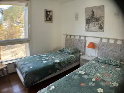 a bedroom with a red and white bed with a window at L'Outa Panoramique in Chamonix-Mont-Blanc