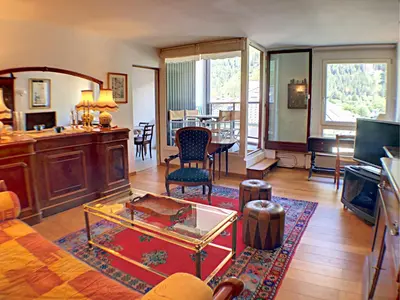 a living room with a table and chairs in it at L'Outa Panoramique in Chamonix-Mont-Blanc