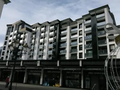 an apartment building in front of a street at L'Outa Panoramique in Chamonix-Mont-Blanc