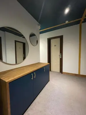 a room with a mirror on the wall and a vanity at Hotel La Verticale in Chamonix-Mont-Blanc