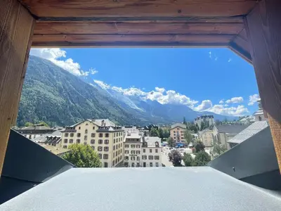 a view from a window of a city with mountains at Hotel La Verticale in Chamonix-Mont-Blanc