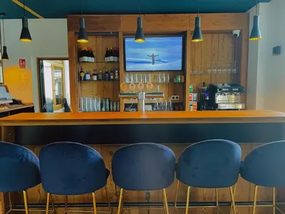 a bar with blue stools in a restaurant at Hotel La Verticale in Chamonix-Mont-Blanc