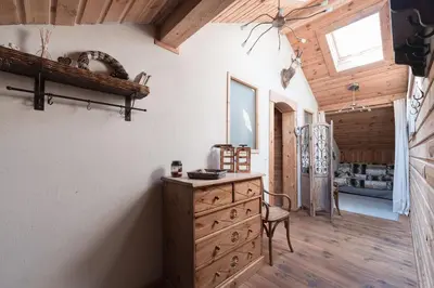 a room with a wooden wall and a iron gate at Appartement Orion à Saint Gervais, proche Chamonix in Saint-Gervais-les-Bains