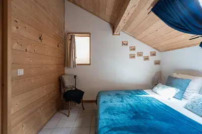 a room with a wooden wall with a chair in it at Appartement Orion à Saint Gervais, proche Chamonix in Saint-Gervais-les-Bains