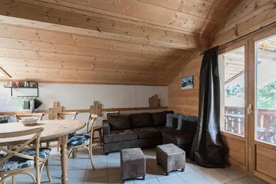 a log cabin in the snow with a dirt road at Appartement Orion à Saint Gervais, proche Chamonix in Saint-Gervais-les-Bains