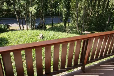 a wooden bench sitting on the side of a park at Tifanlo in Samoëns