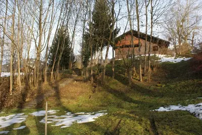a house in the woods with snow on the ground at Tifanlo in Samoëns