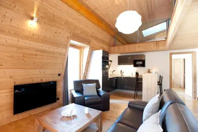 a living room with a couch and a table at Quartz-Montblanc in Chamonix-Mont-Blanc