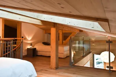 a bedroom with a bed in a room with wooden ceilings at Quartz-Montblanc in Chamonix-Mont-Blanc