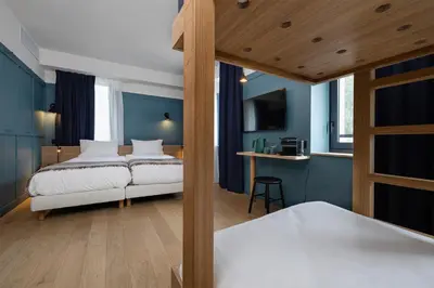 a bedroom with a bed and a desk in a room at Hôtel Restaurant la Couronne in Chamonix-Mont-Blanc