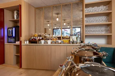 a bar in a restaurant with a counter at Hôtel Restaurant la Couronne in Chamonix-Mont-Blanc