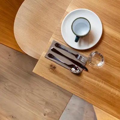 a table with a spoon and a mirror on it at Hôtel Restaurant la Couronne in Chamonix-Mont-Blanc