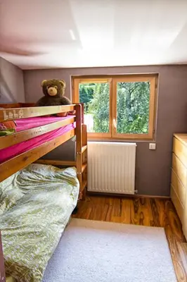 a bedroom with a bunk bed with a teddy bear on top at Le Mont Fleuri Saint Gervais Les Bains in Saint-Gervais-les-Bains