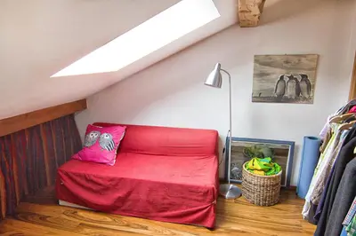 a room with a red bed in a attic at Le Mont Fleuri Saint Gervais Les Bains in Saint-Gervais-les-Bains