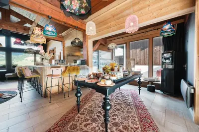 a kitchen with a table in the middle of a room at Mamie Megève in Megève