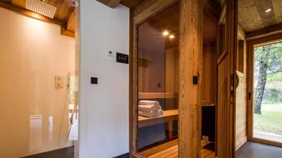 a room with a glass door and a mirror at Chalet Rass in Chamonix-Mont-Blanc