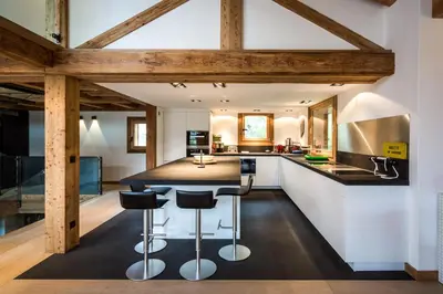 a kitchen with a large island with bar stools at Chalet Rass in Chamonix-Mont-Blanc