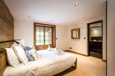 a bedroom with a large white bed with white pillows at Chalet Rass in Chamonix-Mont-Blanc