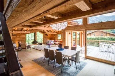 a dining room and living room with a table and chairs at Chalet Rass in Chamonix-Mont-Blanc