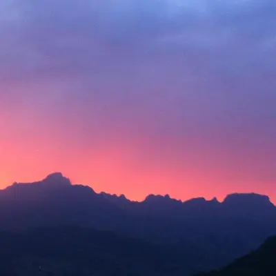 a sunset over the mountains with a pink and purple sky at Les Fourges in Saint-Gervais-les-Bains