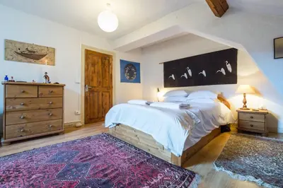 a bedroom with a large bed and a dresser at Les Fourges in Saint-Gervais-les-Bains