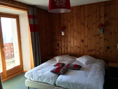 a bedroom with a bed with two pillows on it at Edelweiss in Samoëns