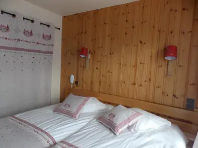 a bedroom with a bed with two pillows on it at Edelweiss in Samoëns