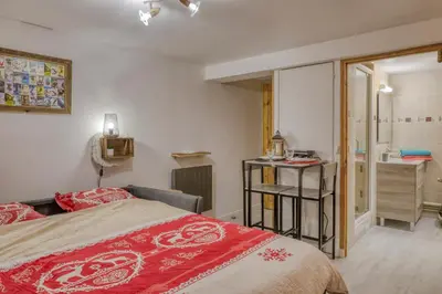 a bedroom with a bed and a bathroom with a sink at Studio 
