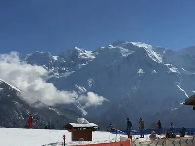 a group of people standing on top of a snow covered mountain at Meridies in Plateau dʼAssy