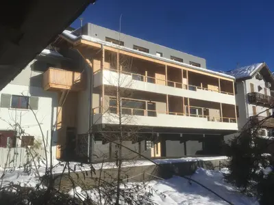 a building with snow in front of it at Meridies in Plateau dʼAssy