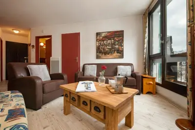 a living room with a couch and a coffee table at Chamonix Sud - Marguerite B215 - Happy Rentals in Chamonix-Mont-Blanc