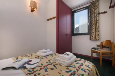 a hotel room with two beds with towels on them at Chamonix Sud - Marguerite B215 - Happy Rentals in Chamonix-Mont-Blanc