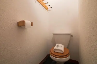 a bathroom with a toilet with two towels on it at Chamonix Sud - Marguerite B215 - Happy Rentals in Chamonix-Mont-Blanc