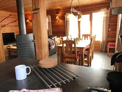 a kitchen and dining room of a log cabin at Chalet La Grande Ourse in Saint-Gervais-les-Bains