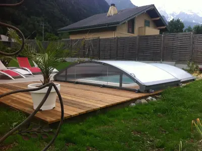 a hot tub on a wooden deck in a yard at Chalet La Grande Ourse in Saint-Gervais-les-Bains