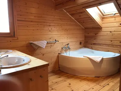 a bathroom with a tub and a sink at Chalet La Grande Ourse in Saint-Gervais-les-Bains