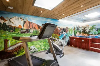 a room with a mountain mural on the wall at Chalet Base Camp in Les Houches