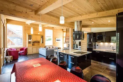a kitchen with a red table in a room at Chalet Base Camp in Les Houches