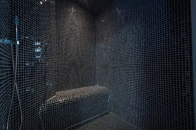 a black tiled bathroom with a shower and a toilet at Chalet Base Camp in Les Houches