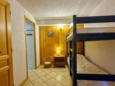 a bedroom with a bunk bed and a desk at Appartement spacieux au centre station avec balcon, 3 pièces pour 8 personnes - FR-1-425-2 in Flaine