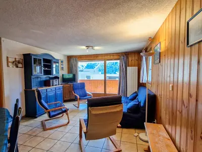 a living room with a blue couch and chairs at Appartement spacieux au centre station avec balcon, 3 pièces pour 8 personnes - FR-1-425-2 in Flaine