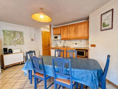 a kitchen and dining room with a table and chairs at Appartement spacieux au centre station avec balcon, 3 pièces pour 8 personnes - FR-1-425-2 in Flaine