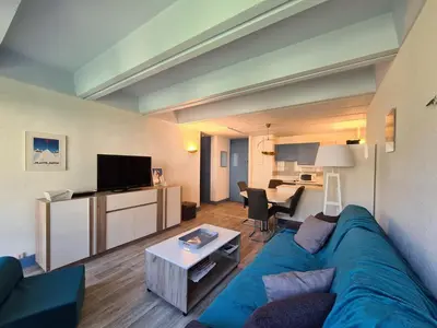 a living room with a blue couch and a table at Appartement rénové près des pistes - Balcon, 5/6 pers. - FR-1-425-47 in Flaine