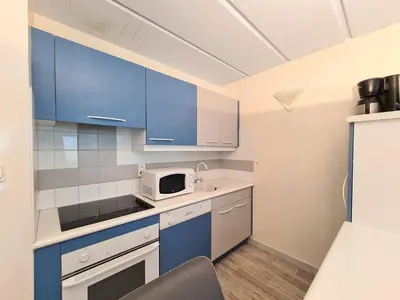 a kitchen with blue cabinets and a microwave at Appartement rénové près des pistes - Balcon, 5/6 pers. - FR-1-425-47 in Flaine