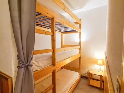 a room with two bunk beds with a curtain at Studio lumineux au centre de Flaine avec balcon, équipé pour 4 personnes - FR-1-425-80 in Flaine