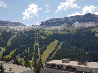 a view of a mountain with trees and a building at Studio lumineux au centre de Flaine avec balcon, équipé pour 4 personnes - FR-1-425-80 in Flaine