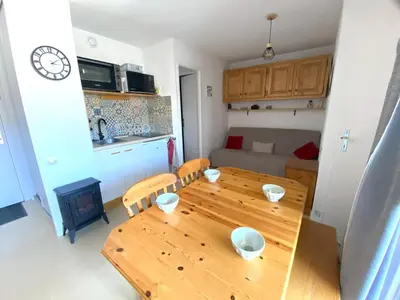 a kitchen and dining room with a wooden table at Appartement cosy 2 pièces pour 4 à Morillon 1100, proche pistes - FR-1-815-65 in Morillon