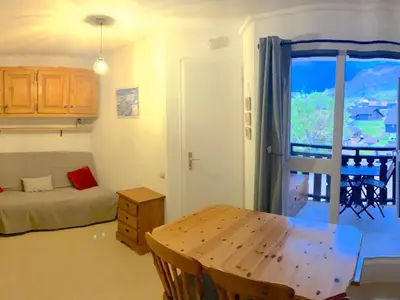 a room with a bed and a table and a window at Appartement cosy 2 pièces pour 4 à Morillon 1100, proche pistes - FR-1-815-65 in Morillon