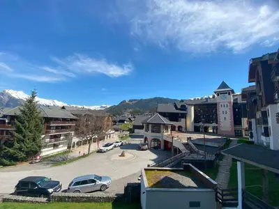 a small town with cars parked in a parking lot at Appartement cosy 2 pièces pour 4 à Morillon 1100, proche pistes - FR-1-815-65 in Morillon